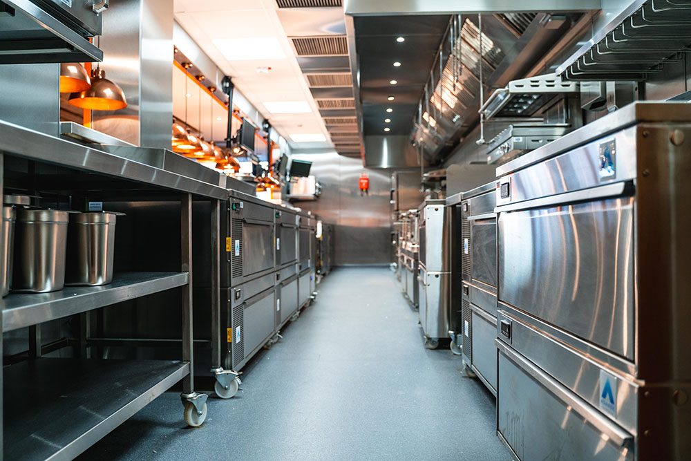 an industrial looking kitchen with various appliances fitted under counter